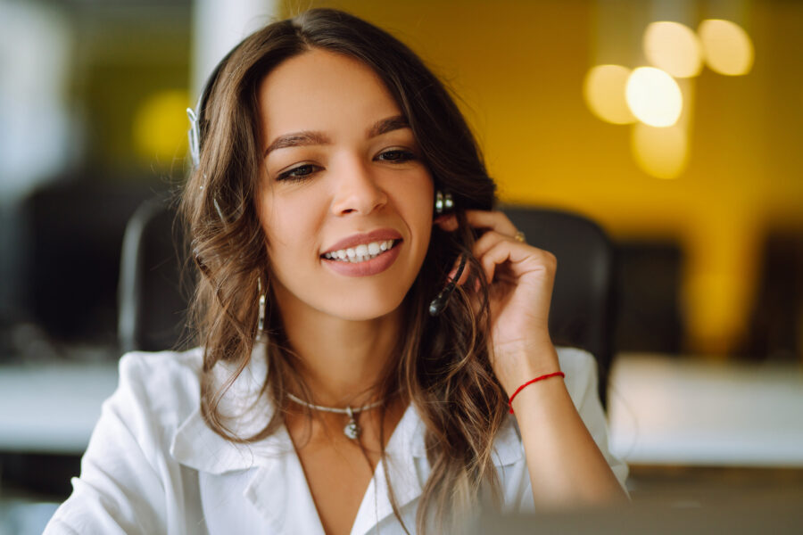Young operator woman agent with headsets working in a call centr